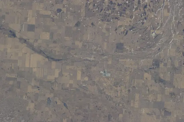 Aerial view of farmland and a town from space